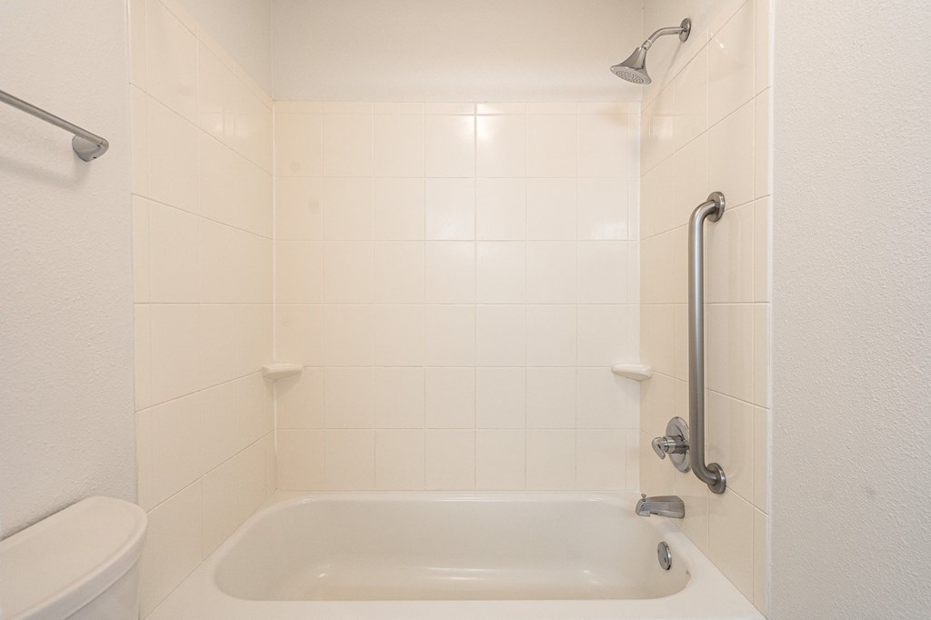 a bathroom with a bathtub and shower